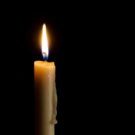 47375779-single-burning-candle-on-a-black-background